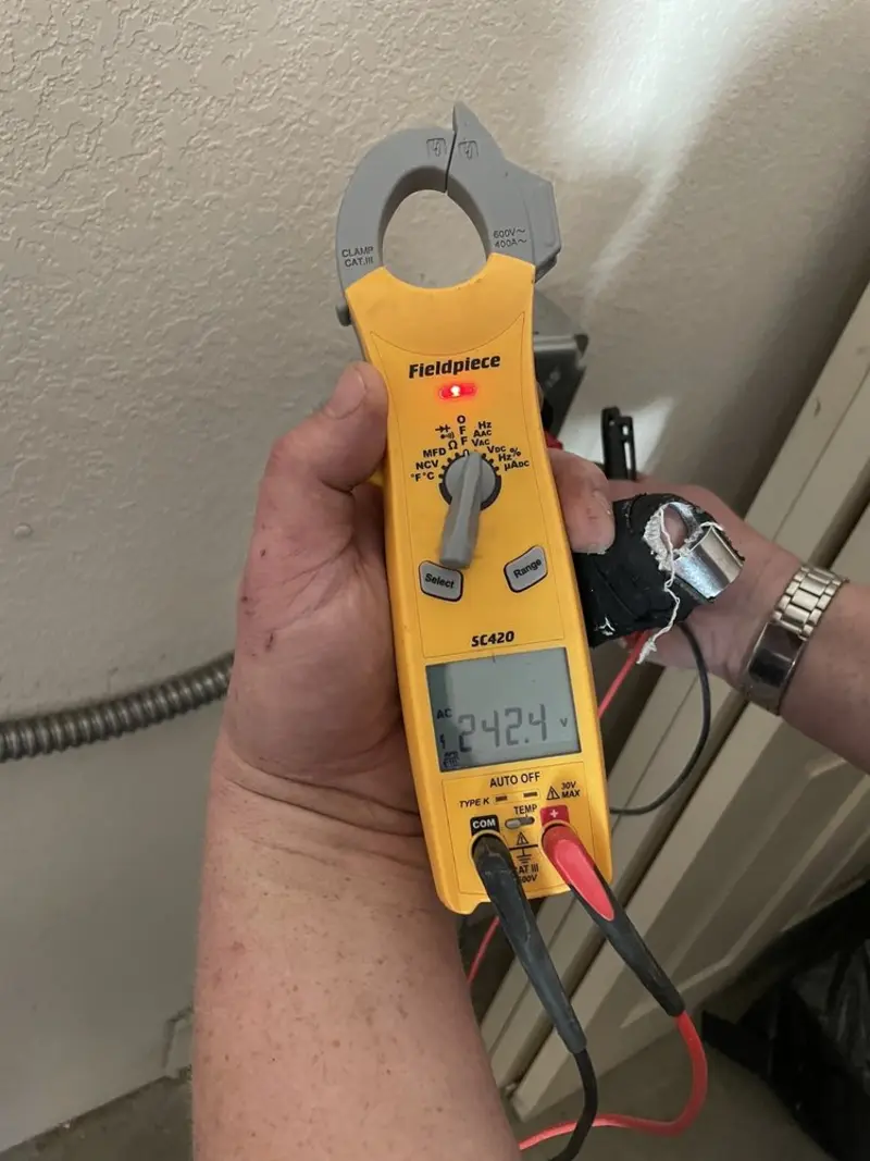 Voltage testing with clamp meter during Electrical Installation Services in Konterra